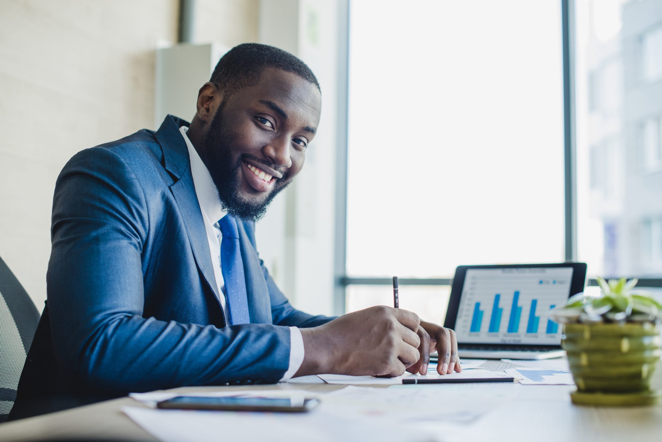 smiling-businessman-signing-contract